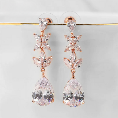 a pair of pink and white earrings hanging from a hook