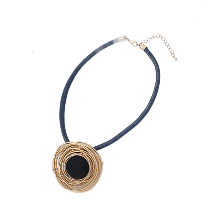 a black and gold necklace with a black circle on it