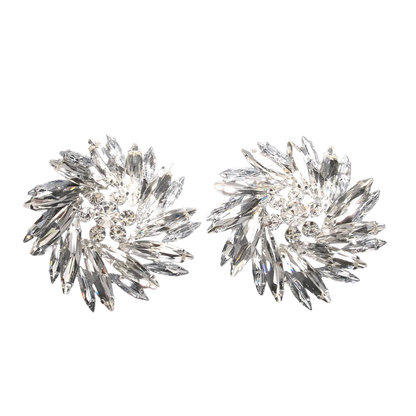 a pair of crystal earrings on a black background