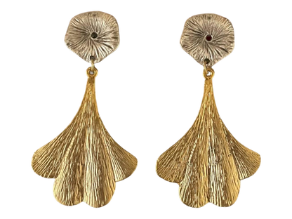 a pair of gold earrings with large fan shaped petals