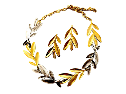 a gold and silver bracelet with leaves on it