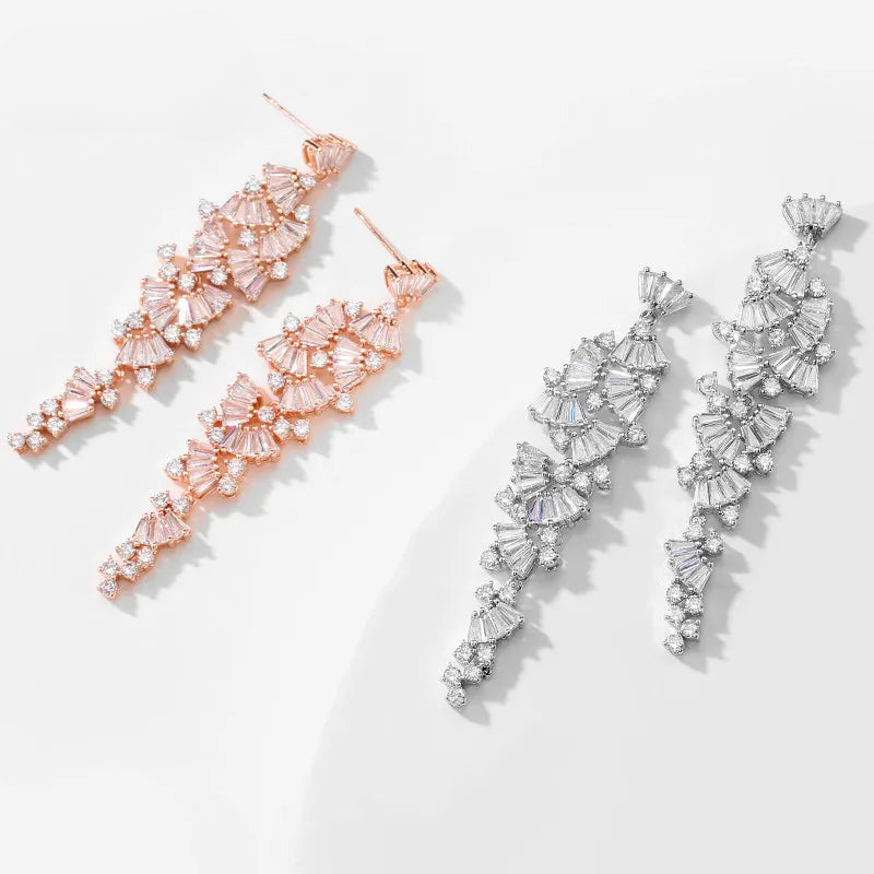 three pairs of earrings on a white surface