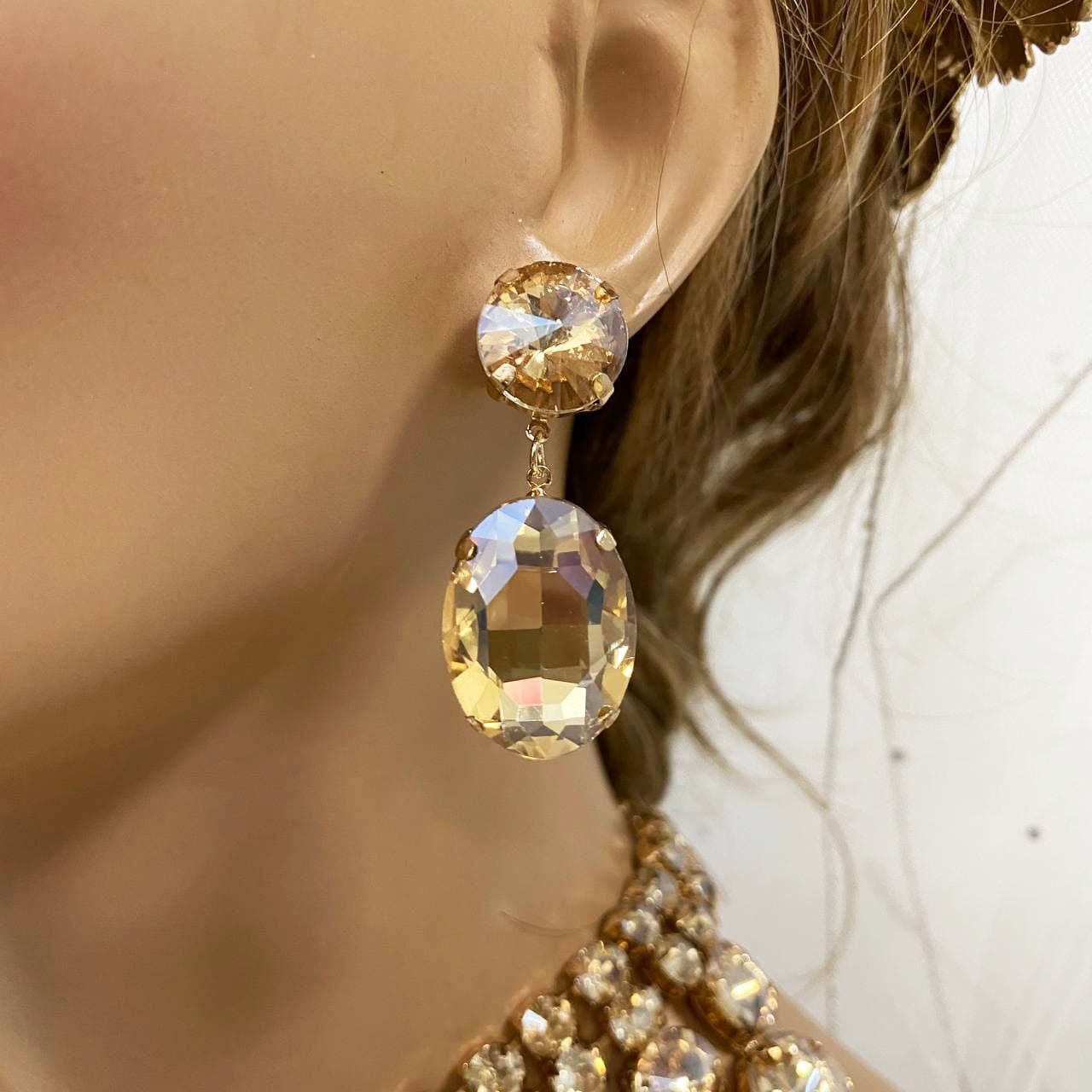 a close up of a person wearing a pair of earrings