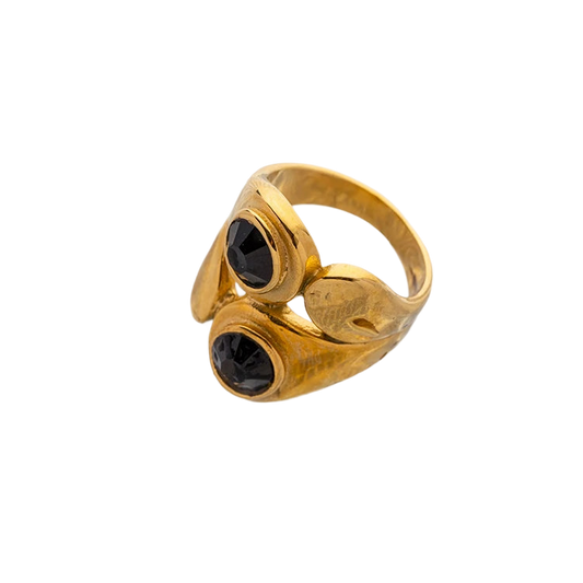 a gold ring with two black stones