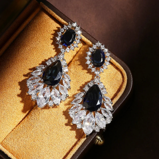 a pair of diamond and sapphire earrings