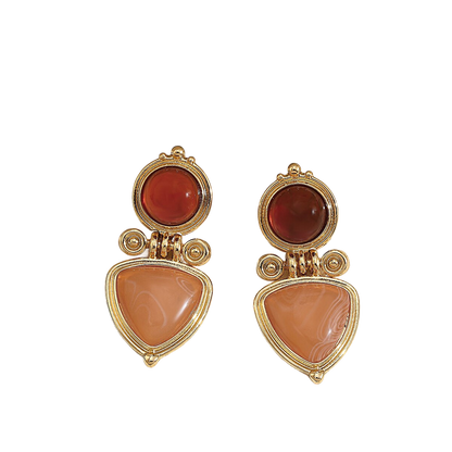 a pair of gold and coral earrings