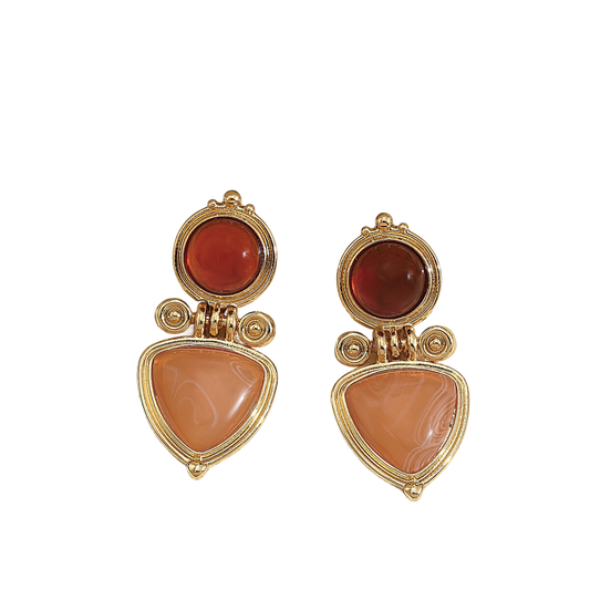 a pair of gold and coral earrings