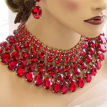 a woman wearing a red necklace and earrings