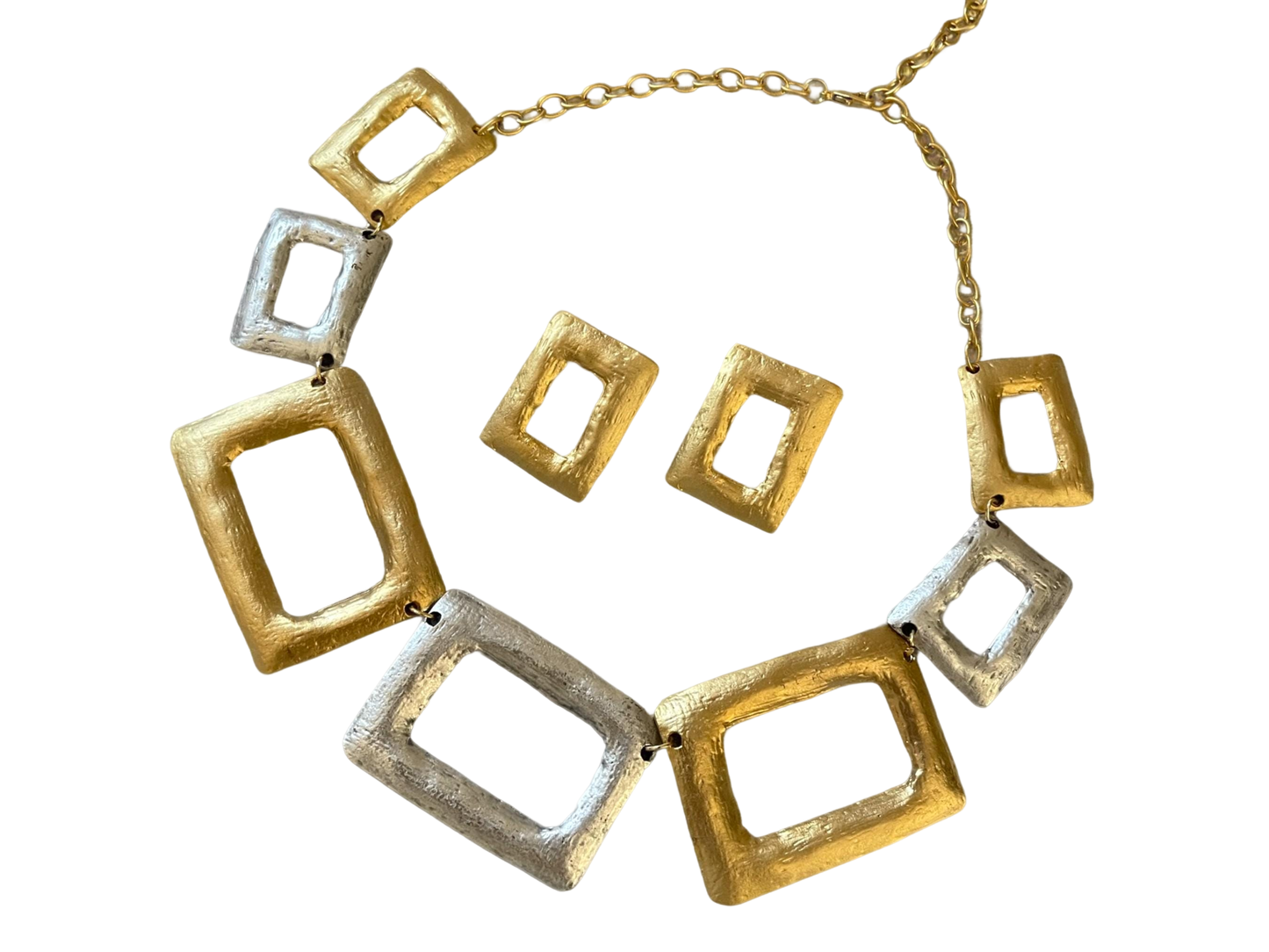 a gold and silver necklace and matching earrings