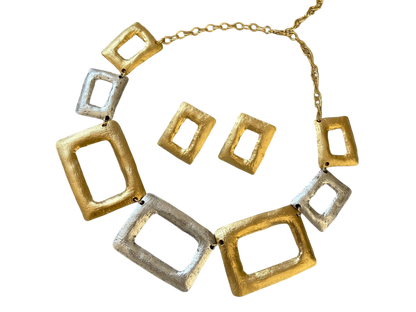 a gold and silver necklace and matching earrings