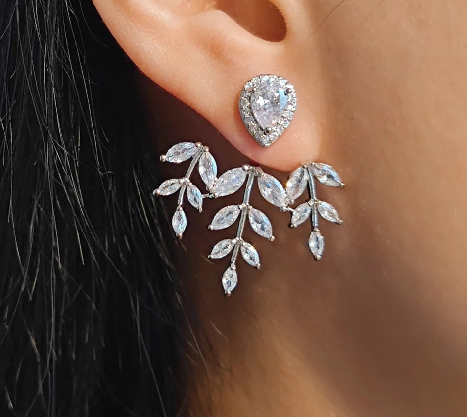 a close up of a person wearing a pair of earrings